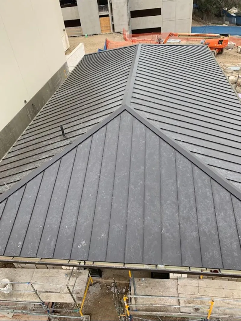 Commercial metal roof construction with crane equipment in La Crosse