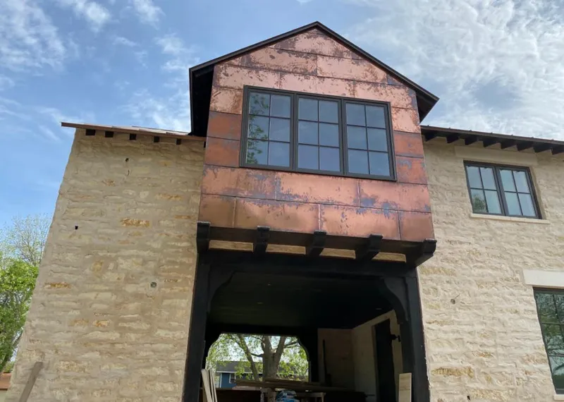 Copper metal panel facade on a stone building for Skylight Installation in La Crosse